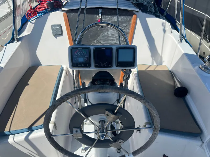 Slide: The Image of Cockpit of a 1983 Hunter 27 sailboat with navigation instruments and steering wheel. - 8