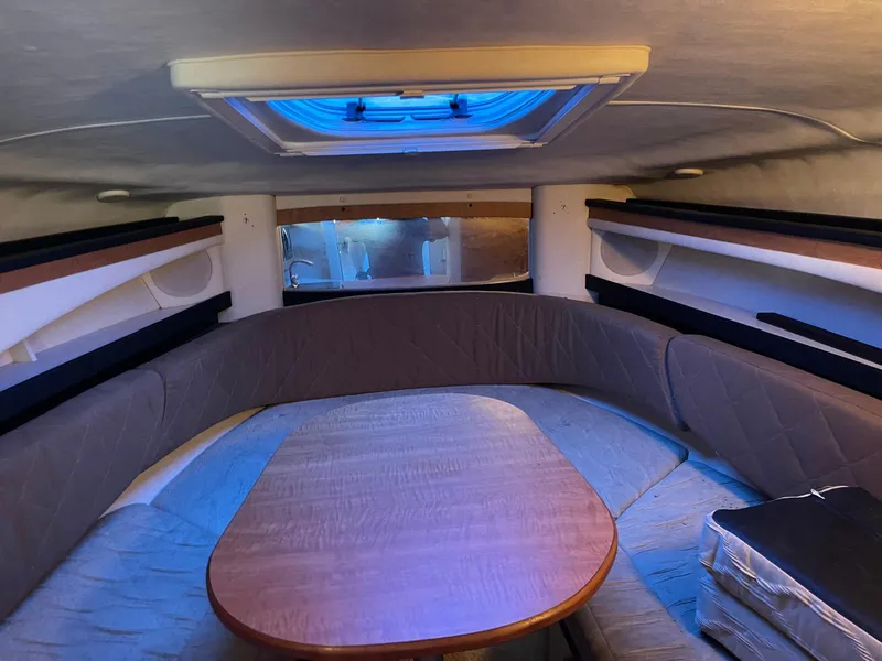 Slide: The Image of Interior cabin of a 2006 Sea Ray 270 Amberjack boat with seating and table. - 10