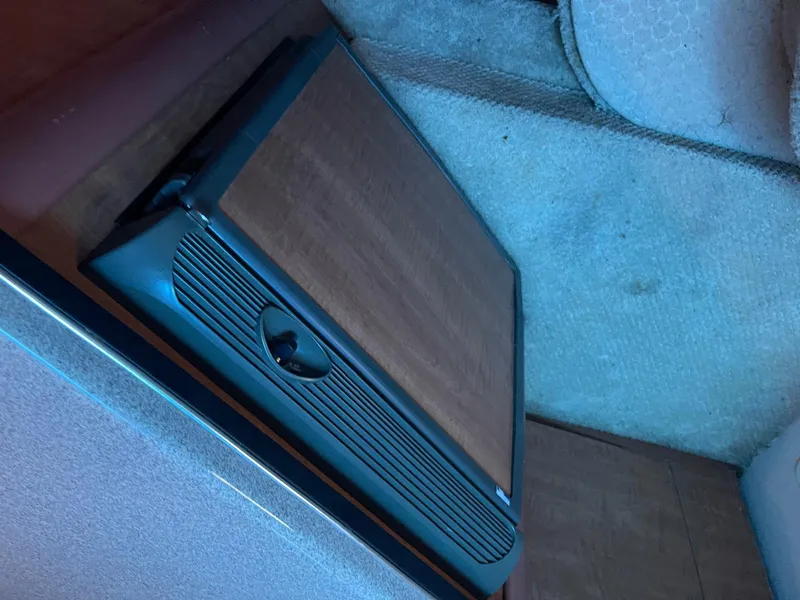 Slide: The Image of 2006 Sea Ray 270 Amberjack cabin interior with wooden paneling and carpeted flooring. - 12