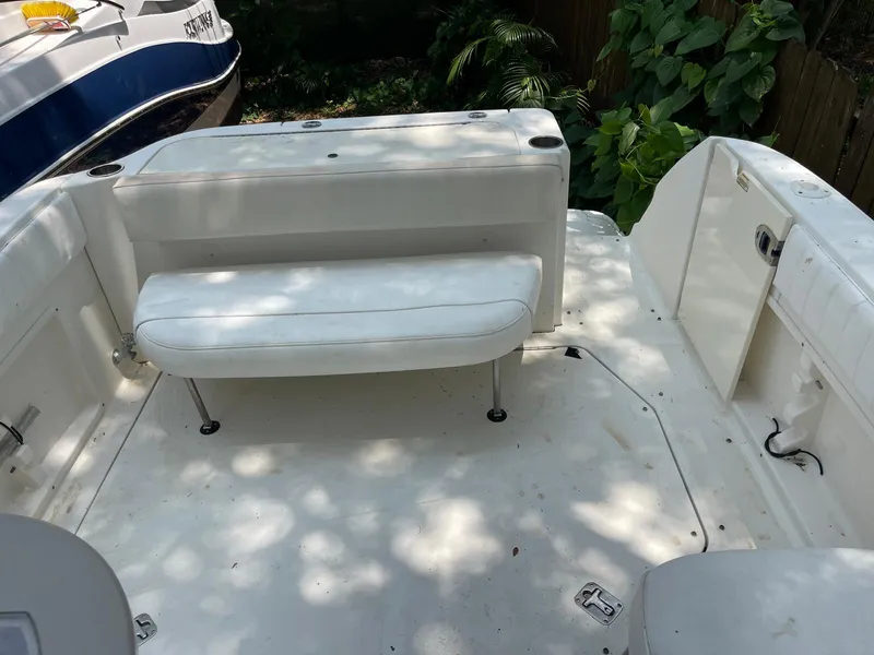 Slide: The Image of 2006 Sea Ray 270 Amberjack boat interior with white seating and spacious deck. - 2