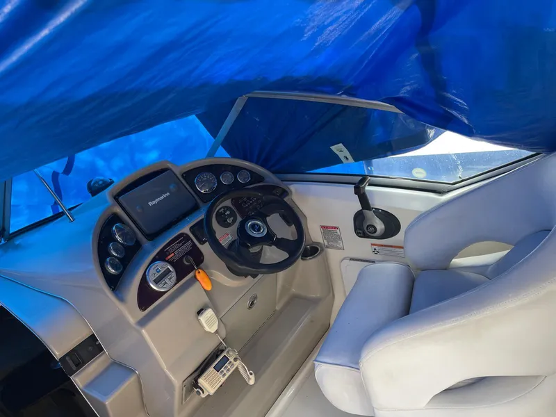 Slide: The Image of 2006 Sea Ray 270 Amberjack boat cockpit with steering wheel and navigation equipment. - 3