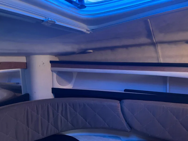 Slide: The Image of Interior cabin of a 2006 Sea Ray 270 Amberjack boat with blue ambient lighting. - 8