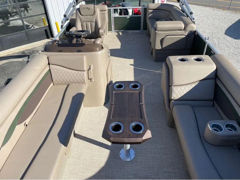 Slide: The Image of 2023 Bennington 20 SSRSP pontoon boat interior with beige seating and central table. - 3
