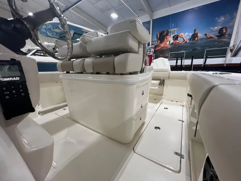 Slide: The Image of 2025 Boston Whaler 250 Outrage interior with seating and storage compartments. - 12
