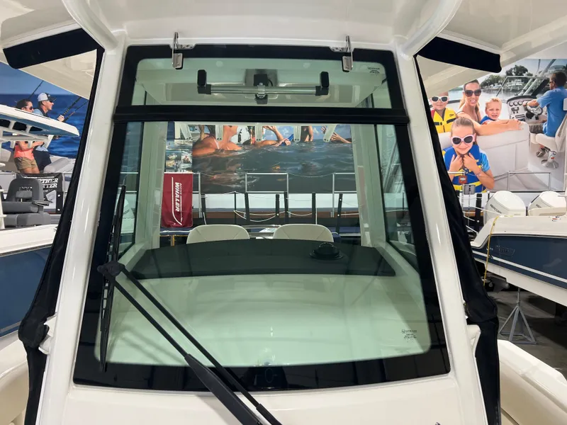 Slide: The Image of 2025 Boston Whaler 250 Outrage boat windshield in showroom display. - 16