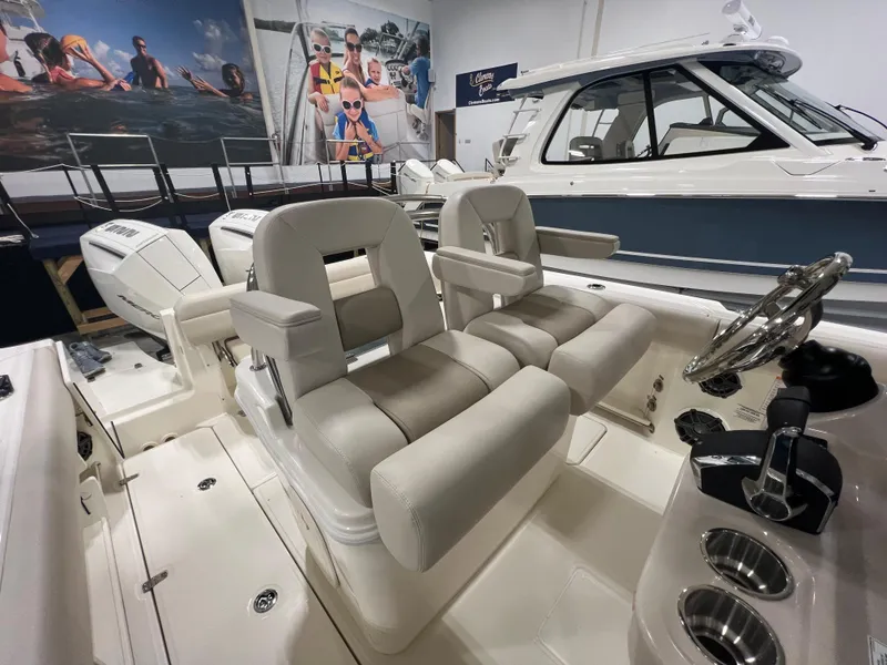 Slide: The Image of 2025 Boston Whaler 250 Outrage boat interior with dual seating and modern controls. - 7