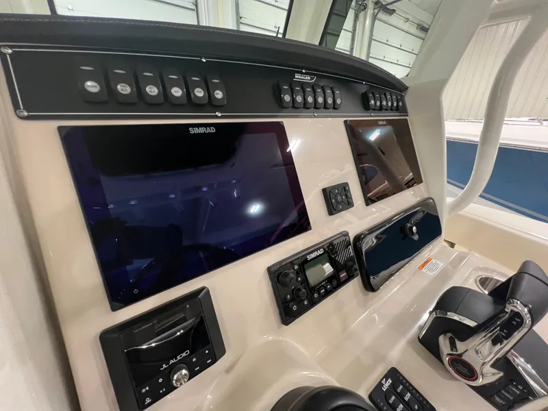 Slide: The Image of 2025 Boston Whaler 250 Outrage dashboard with advanced navigation and control systems. - 9