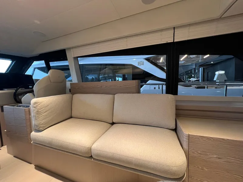 Slide: The Image of Interior of 2024 Ferretti Yachts 500 with beige sofa and large windows. - 18