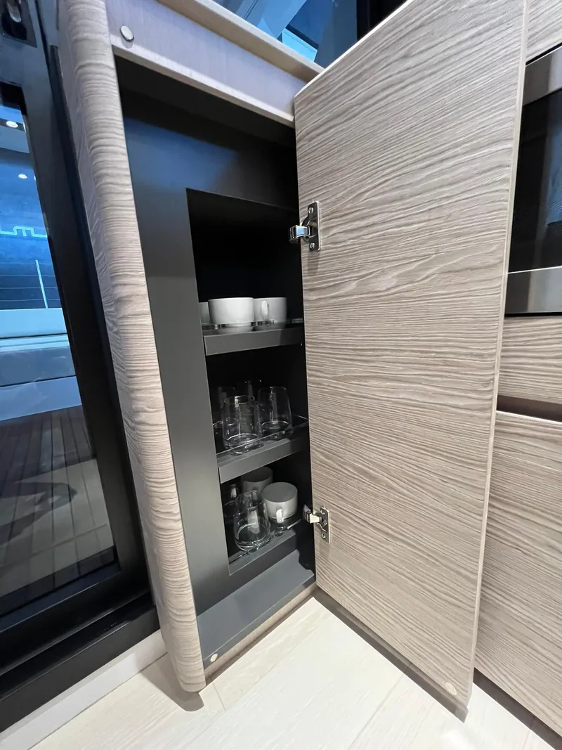 Slide: The Image of Open cabinet in 2024 Ferretti Yachts 500, showcasing glassware and cups. - 20