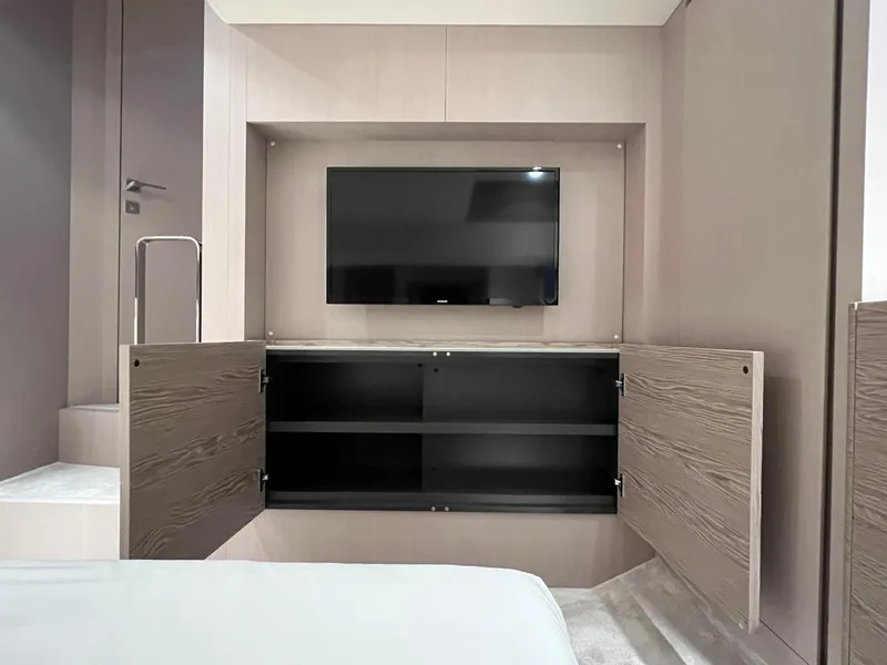 Slide: The Image of Modern interior of 2024 Ferretti Yachts 500 with TV and open storage cabinet. - 43