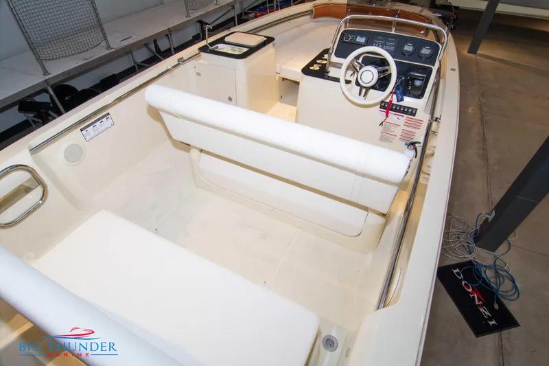 Slide: The Image of 2024 Capoforte SX200 boat interior with white seating and modern dashboard. - 11