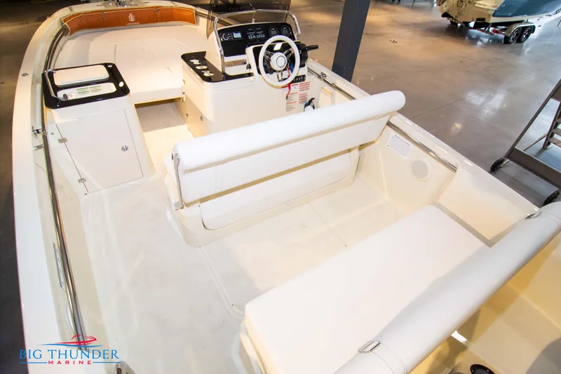 Slide: The Image of 2024 Capoforte SX200 boat interior with white seating and modern dashboard. - 12