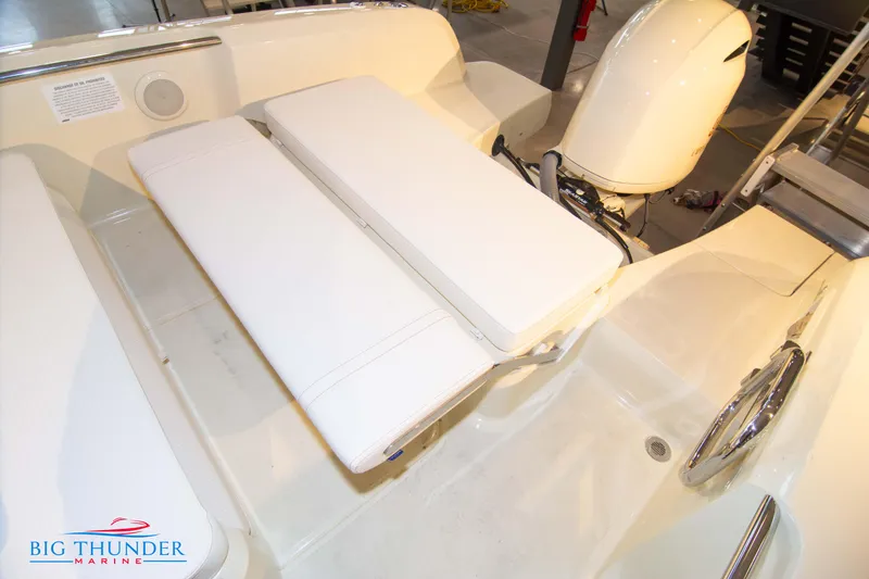 Slide: The Image of 2024 Capoforte SX200 boat interior with cushioned seating and outboard motor. - 14