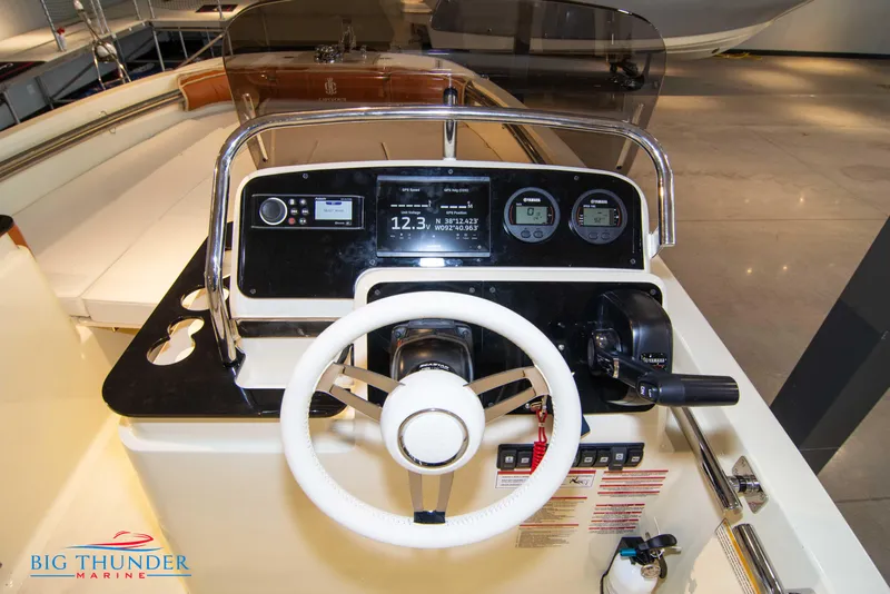 Slide: The Image of 2024 Capoforte SX200 boat dashboard with steering wheel and control panel at Big Thunder Marine. - 17
