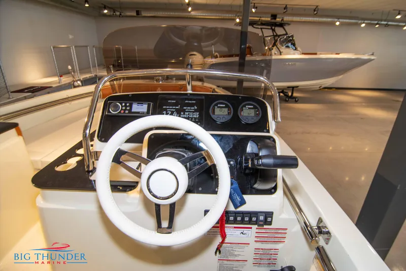 Slide: The Image of 2024 Capoforte SX200 boat dashboard and steering wheel at Big Thunder Marine showroom. - 18