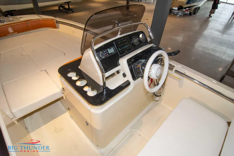Slide: The Image of 2024 Capoforte SX200 boat interior with steering console and seating, displayed at Big Thunder Marine. - 25
