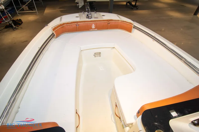 Slide: The Image of 2024 Capoforte SX200 boat interior with cushioned seating and storage. - 31
