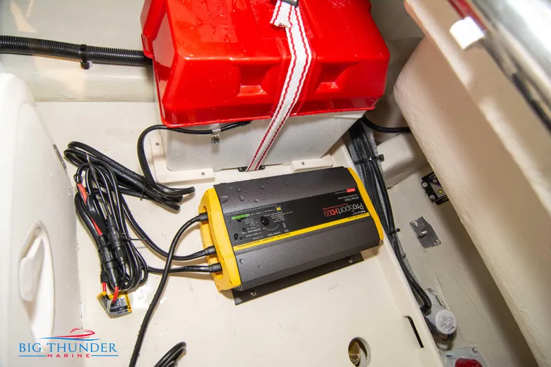 Slide: The Image of Battery compartment of 2024 Capoforte SX200 boat with charger and wiring. - 37