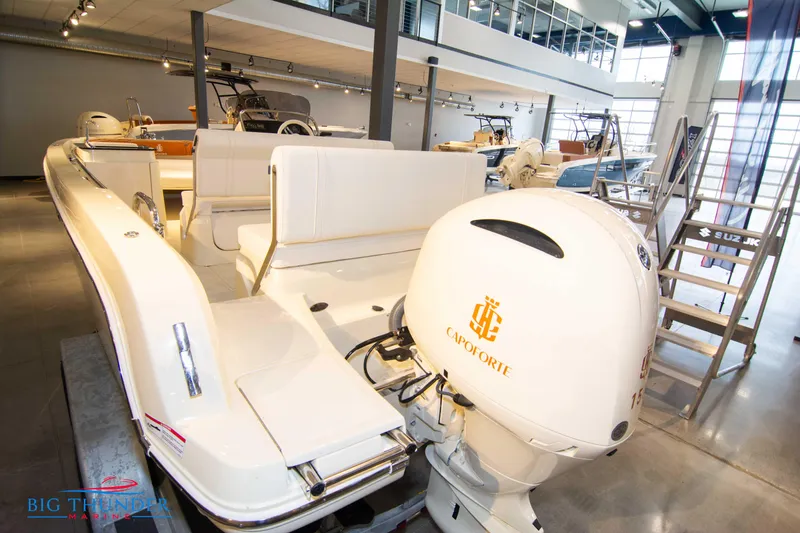 Slide: The Image of 2024 Capoforte SX200 boat in showroom, rear view with outboard motor. - 6