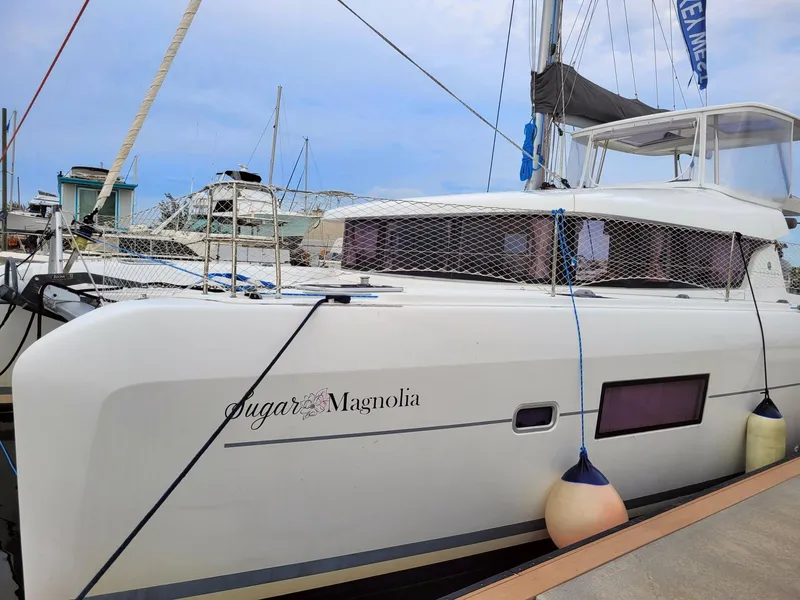 Slide: The Image of 2017 Lagoon 42 catamaran docked at marina, named Sugar Magnolia. - 1
