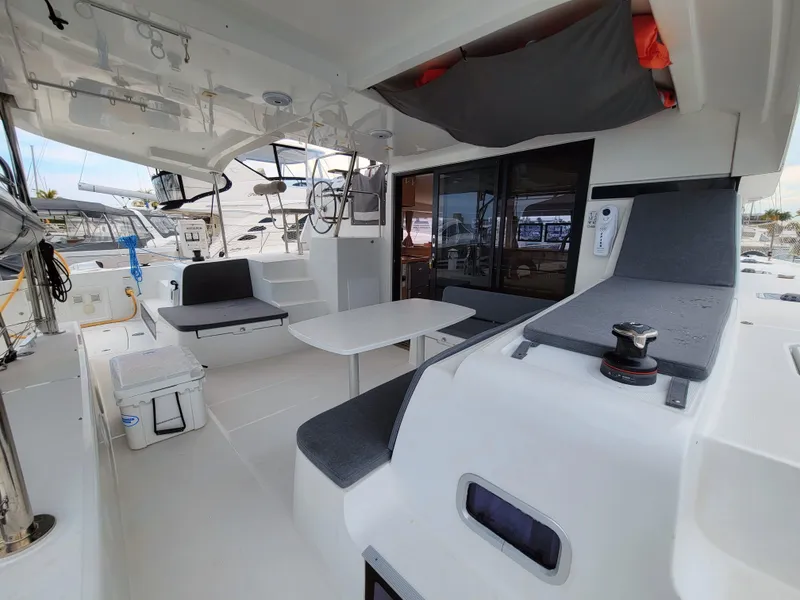 Slide: The Image of Spacious cockpit of 2017 Lagoon 42 catamaran with seating and table. - 13