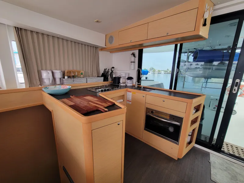 Slide: The Image of Modern kitchen interior of 2017 Lagoon 42 catamaran with wooden cabinetry and ocean view. - 22