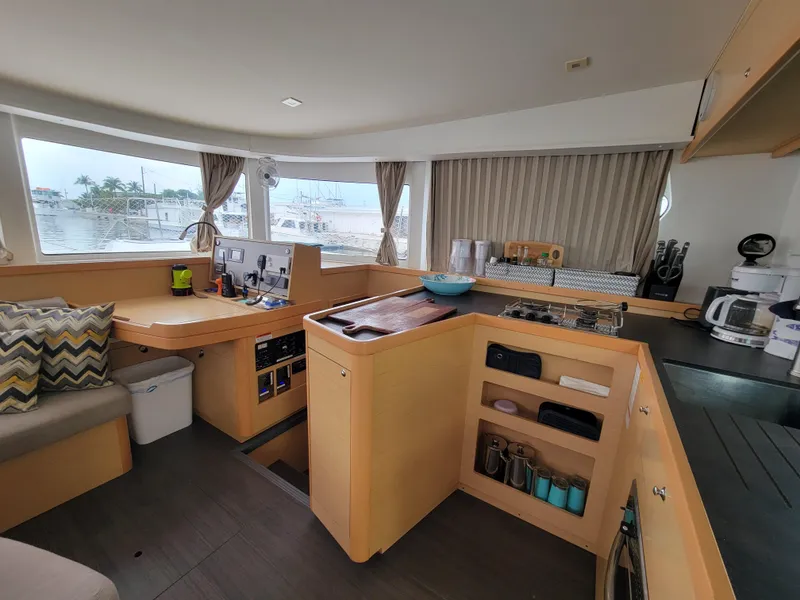 Slide: The Image of Interior of 2017 Lagoon 42 catamaran with modern kitchen and navigation area. - 24