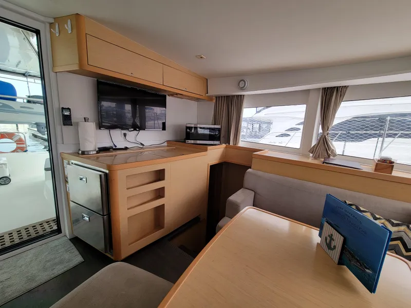 Slide: The Image of Interior of 2017 Lagoon 42 catamaran with modern kitchen and dining area. - 25