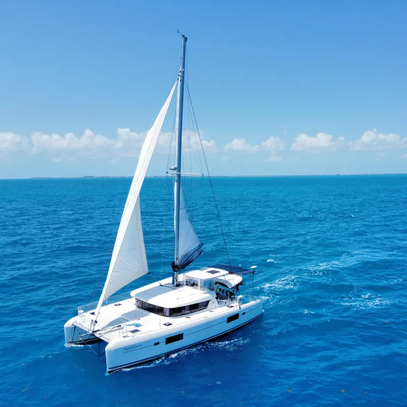 Slide: The Image of 2017 Lagoon 42 catamaran sailing on clear blue ocean. - 31