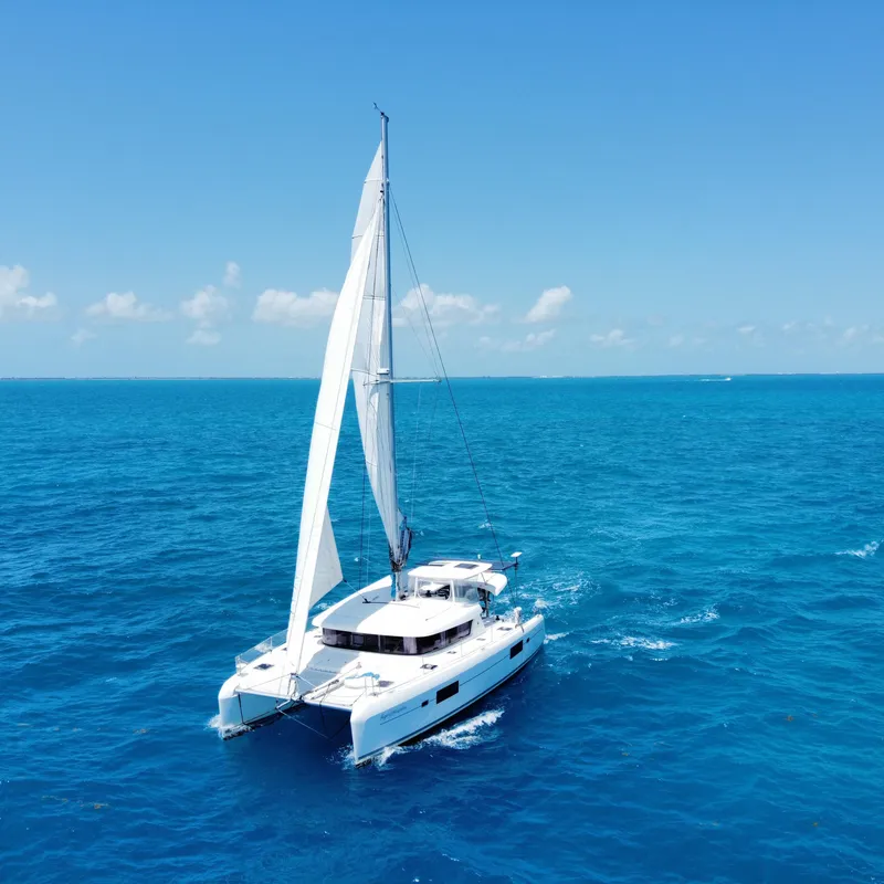 Slide: The Image of Lagoon 42 catamaran sailing in clear blue ocean, 2017 model. - 32