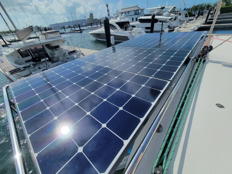 Slide: The Image of Solar panels on a 2017 Lagoon 42 catamaran docked at a marina. - 36