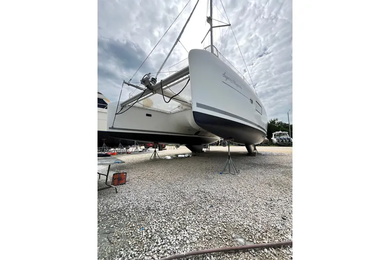 Slide: The Image of 2017 Lagoon 42 catamaran on dry dock, cloudy sky background. - 37