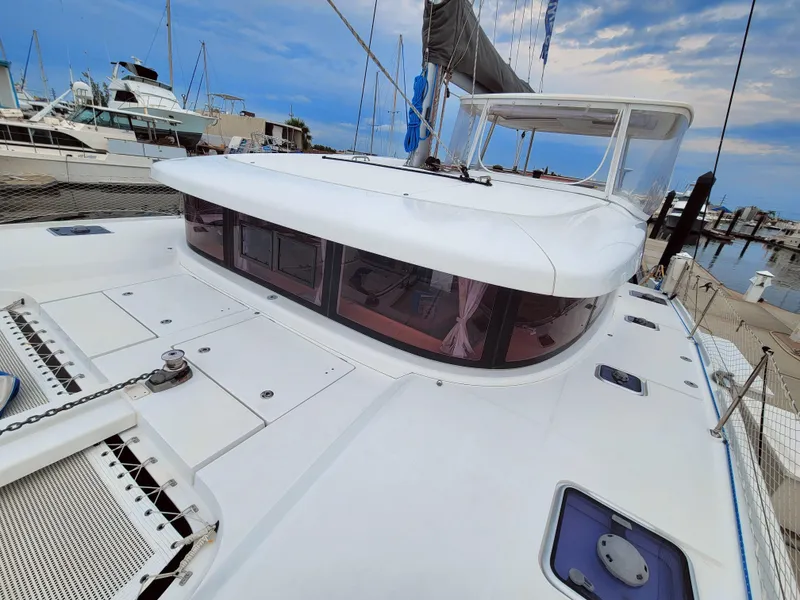 Slide: The Image of 2017 Lagoon 42 catamaran docked at marina with clear sky. - 7