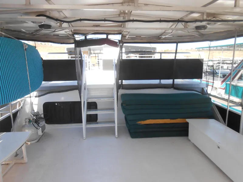Slide: The Image of Upper deck of a 2000 Skipperliner Custom Houseboat with seating and storage. - 20