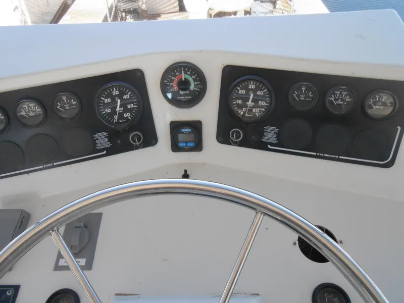 Slide: The Image of Control panel of a 2000 Skipperliner Custom Houseboat with steering wheel and gauges. - 22