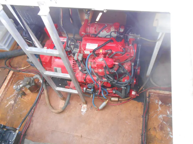 Slide: The Image of Engine compartment of a 2000 Skipperliner Custom Houseboat with red engine and wiring. - 28