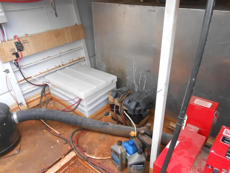 Slide: The Image of Engine room of a 2000 Skipperliner Custom Houseboat with various equipment and wiring. - 33