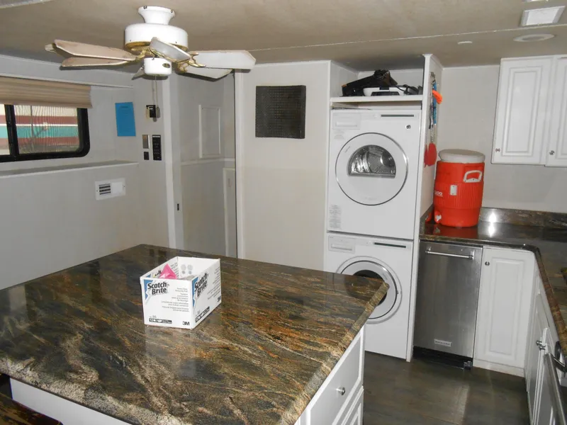 Slide: The Image of 2000 Skipperliner Custom Houseboat interior with kitchen and laundry area. - 6