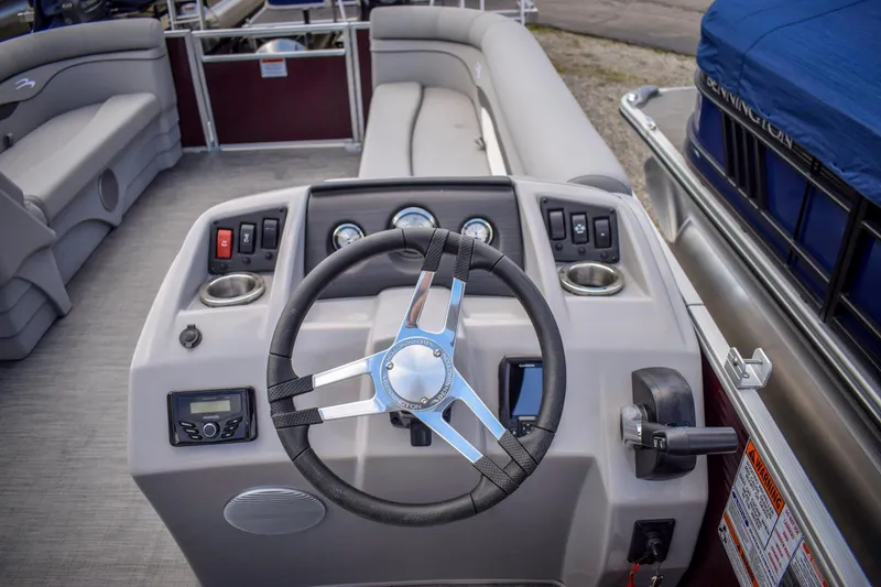 Slide: The Image of 2023 Bennington 21 SLSP boat steering console with gauges and controls. - 10