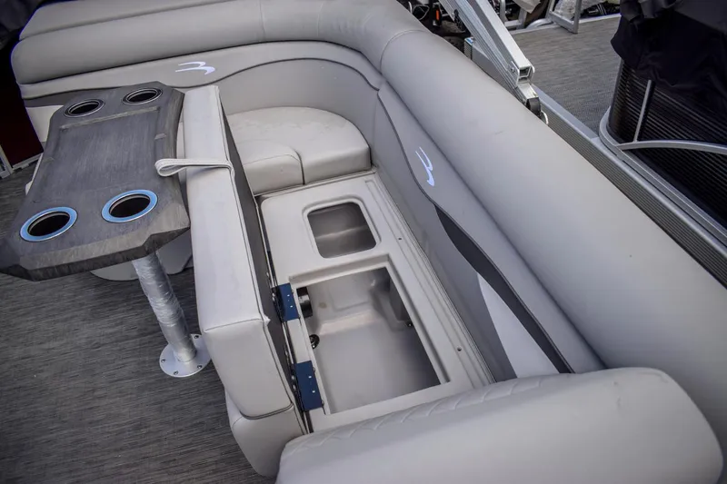 Slide: The Image of 2023 Bennington 21 SLSP pontoon boat with storage compartment and cup holders. - 14