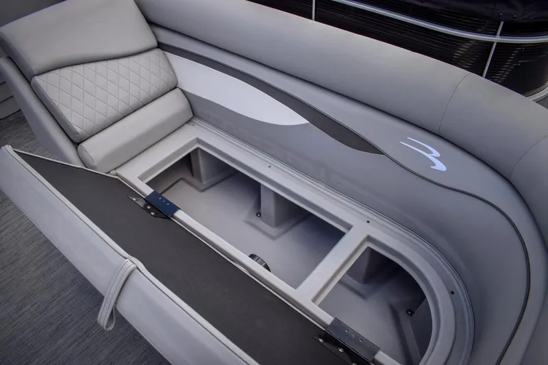 Slide: The Image of 2023 Bennington 21 SLSP boat with open storage compartment and cushioned seating. - 7