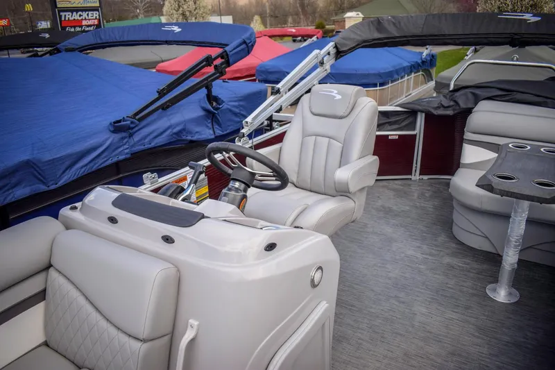 Slide: The Image of 2023 Bennington 21 SLSP pontoon boat interior with captain's chair and covered seating. - 8