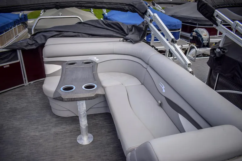 Slide: The Image of 2023 Bennington 21 SLSP pontoon boat with gray seating and table. - 9