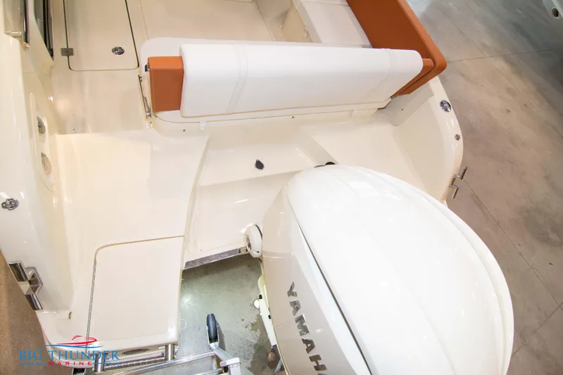 Slide: The Image of 2024 Capoforte CX240 boat with Yamaha outboard motor, white and orange seating. - 10