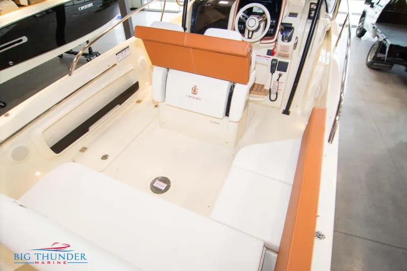 Slide: The Image of 2024 Capoforte CX240 boat interior with white and orange seating, Big Thunder Marine logo. - 13