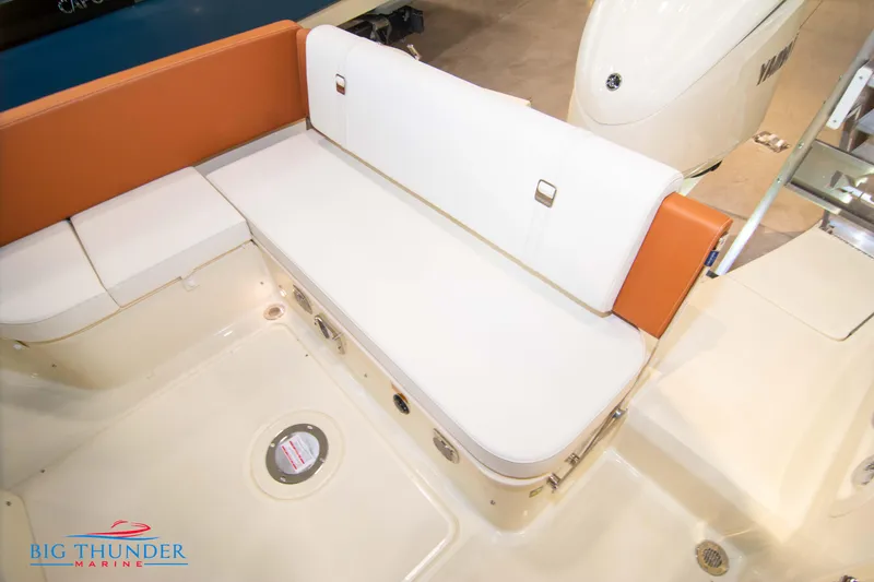 Slide: The Image of Capoforte CX240 2024 boat interior seating with white and orange cushions. - 15