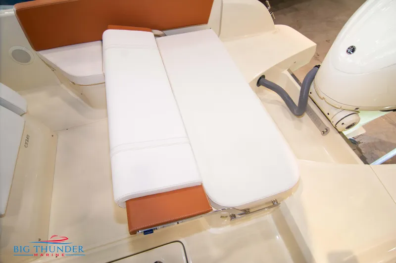 Slide: The Image of 2024 Capoforte CX240 boat seating area with white and brown cushions. - 16
