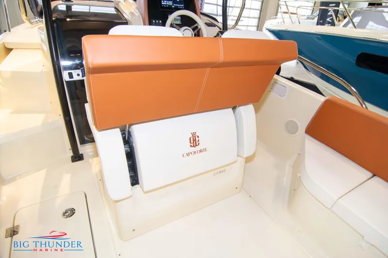 Slide: The Image of 2024 Capoforte CX240 boat interior with tan and white seating, Big Thunder Marine logo. - 19
