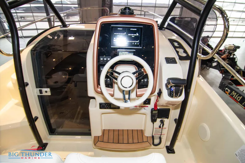 Slide: The Image of 2024 Capoforte CX240 boat helm with modern controls and steering wheel. - 22
