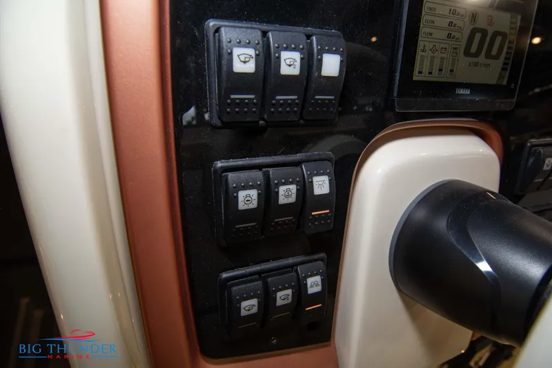 Slide: The Image of Control panel of the 2024 Capoforte CX240 boat with various switches and display. - 26